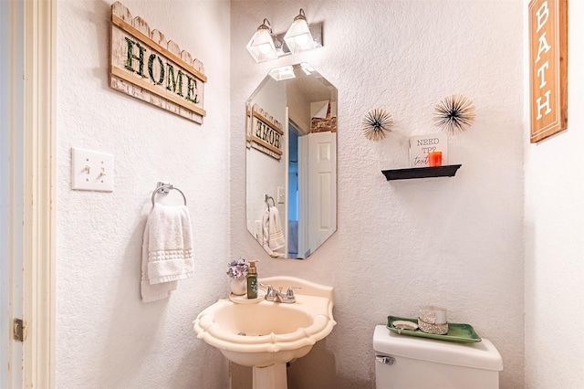 14639 Cypress Cottage Ct, Cypress, TX 77429 - half bath with toilet, a sink, and a textured wall