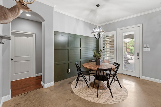 6014 Charrington Dr, Spring, TX 77389 - dining area with finished concrete floors, ornamental molding, a chandelier, baseboards, and arched walkways