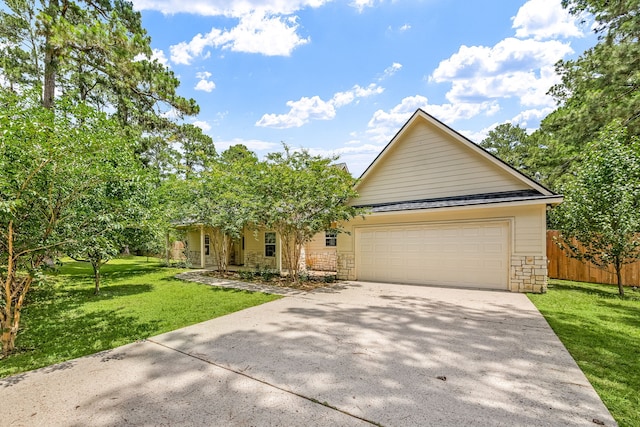 40614 Rolling Forest Dr, Magnolia, TX 77354 - view of front facade featuring concrete driveway, stone siding, and a garage