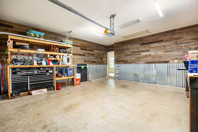 40614 Rolling Forest Dr, Magnolia, TX 77354 - garage with wooden walls, a garage door opener, and a workshop area