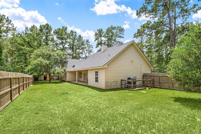 40614 Rolling Forest Dr, Magnolia, TX 77354 - back of house with a chimney, a shingled roof, and a patio area
