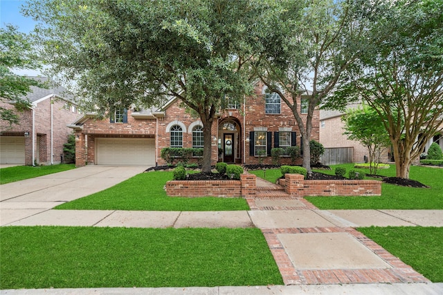 12415 Bunker Cove Dr, Cypress, TX 77433 - view of front facade with a front yard, brick siding, driveway, and an attached garage
