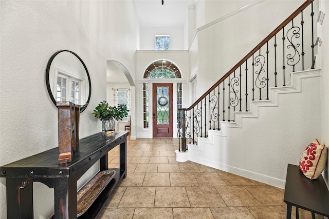 12415 Bunker Cove Dr, Cypress, TX 77433 - foyer with baseboards, a high ceiling, stairway, and arched walkways