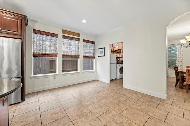 12415 Bunker Cove Dr, Cypress, TX 77433 - unfurnished dining area featuring a chandelier, arched walkways, baseboards, recessed lighting, and light tile patterned flooring