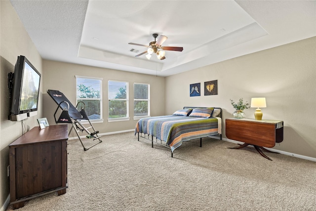 12415 Bunker Cove Dr, Cypress, TX 77433 - carpeted bedroom featuring a tray ceiling, baseboards, and a ceiling fan