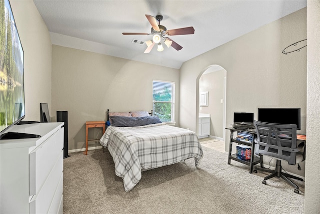 12415 Bunker Cove Dr, Cypress, TX 77433 - bedroom with a desk, light colored carpet, arched walkways, ensuite bathroom, and a ceiling fan