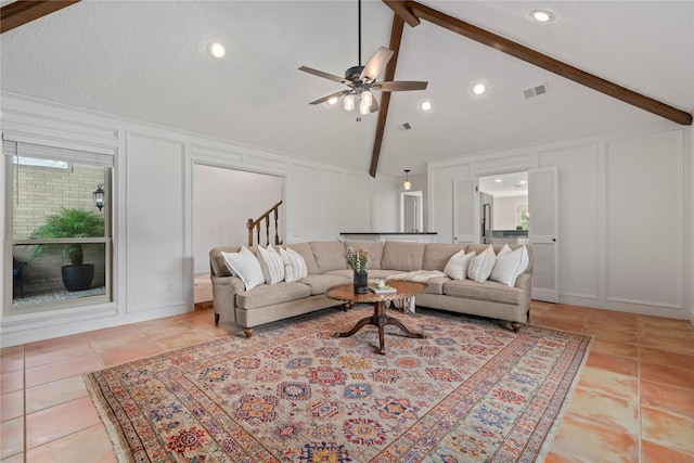 20611 Shillington Ct, Katy, TX 77450 - living room featuring a decorative wall, beamed ceiling, light tile patterned floors, a ceiling fan, and high vaulted ceiling