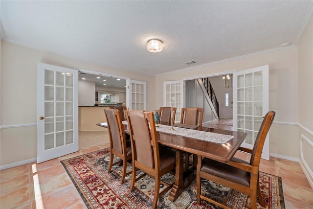 20611 Shillington Ct, Katy, TX 77450 - dining room featuring french doors, crown molding, stairway, tile patterned flooring, and a textured ceiling