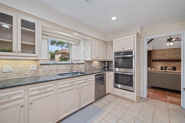 20611 Shillington Ct, Katy, TX 77450 - kitchen featuring stainless steel appliances, a sink, ceiling fan, backsplash, and light tile patterned floors