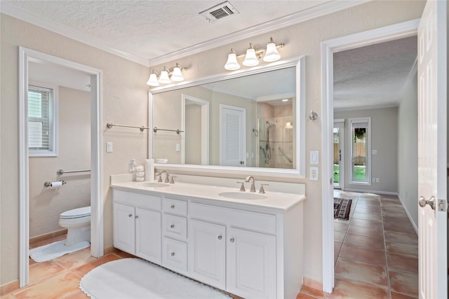 20611 Shillington Ct, Katy, TX 77450 - bathroom featuring ornamental molding, a textured ceiling, double vanity, healthy amount of natural light, and tile patterned floors