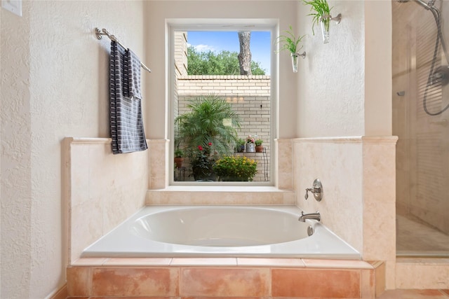 20611 Shillington Ct, Katy, TX 77450 - bathroom featuring a shower stall, a bath, and a textured wall
