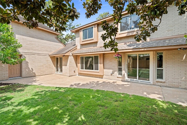 20611 Shillington Ct, Katy, TX 77450 - rear view of house with brick siding, a shingled roof, a yard, and a patio area