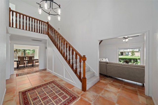 20611 Shillington Ct, Katy, TX 77450 - staircase with a towering ceiling, tile patterned floors, a ceiling fan, and baseboards