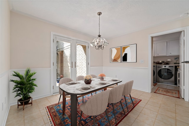 20611 Shillington Ct, Katy, TX 77450 - dining room featuring washing machine and clothes dryer, a chandelier, light tile patterned floors, ornamental molding, and a textured ceiling
