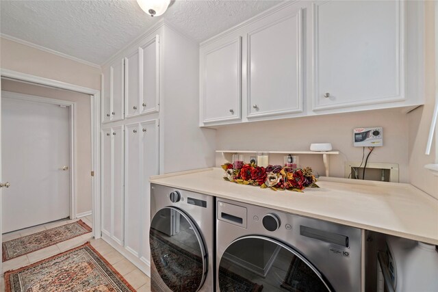 20611 Shillington Ct, Katy, TX 77450 - washroom with cabinet space, washer and dryer, light tile patterned floors, a textured ceiling, and baseboards