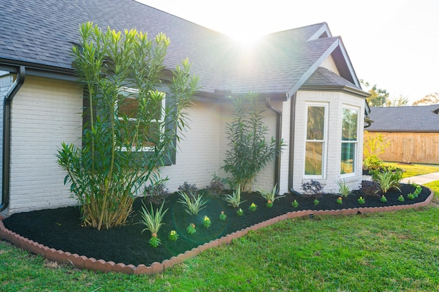 9219 Pecos St, Houston, TX 77055 - view of property exterior with brick siding, a shingled roof, and a yard