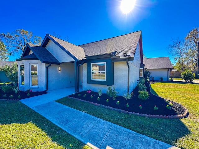9219 Pecos St, Houston, TX 77055 - ranch-style house featuring brick siding, a front lawn, and a shingled roof