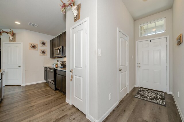 5766 Cerrillos Dr, Bryan, TX 77807 - entryway with light wood-style floors, baseboards, and recessed lighting
