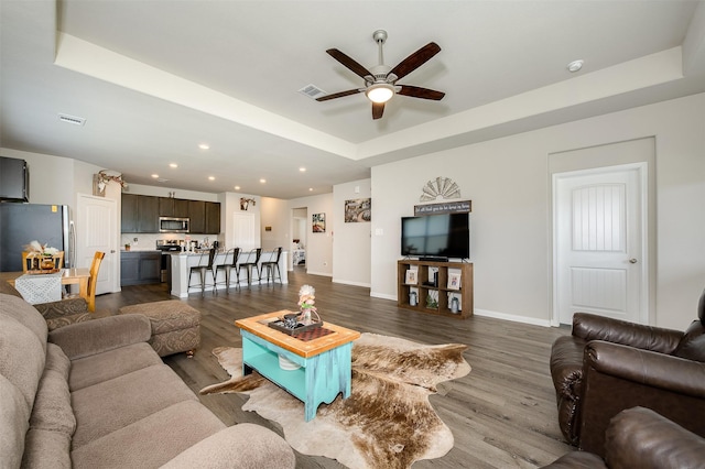 5766 Cerrillos Dr, Bryan, TX 77807 - living area featuring a ceiling fan, a raised ceiling, dark wood-style flooring, recessed lighting, and baseboards