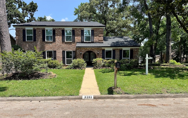3311 Big Spruce Dr, Kingwood, TX 77339 - view of front facade featuring a front yard and brick siding