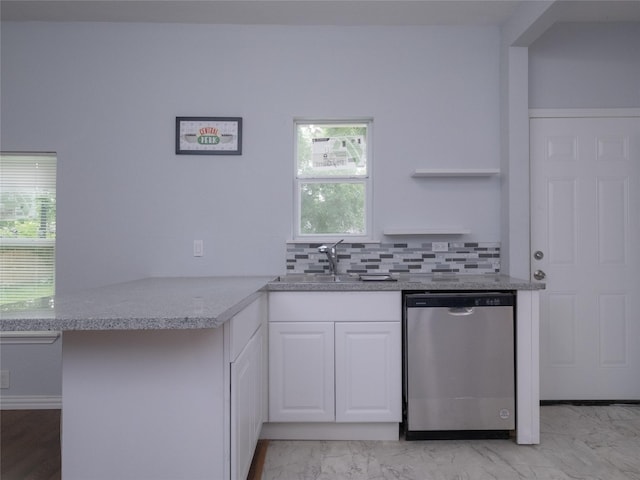 2703 Areba St, Houston, TX 77091 - kitchen with dishwasher, a sink, white cabinetry, a peninsula, and backsplash