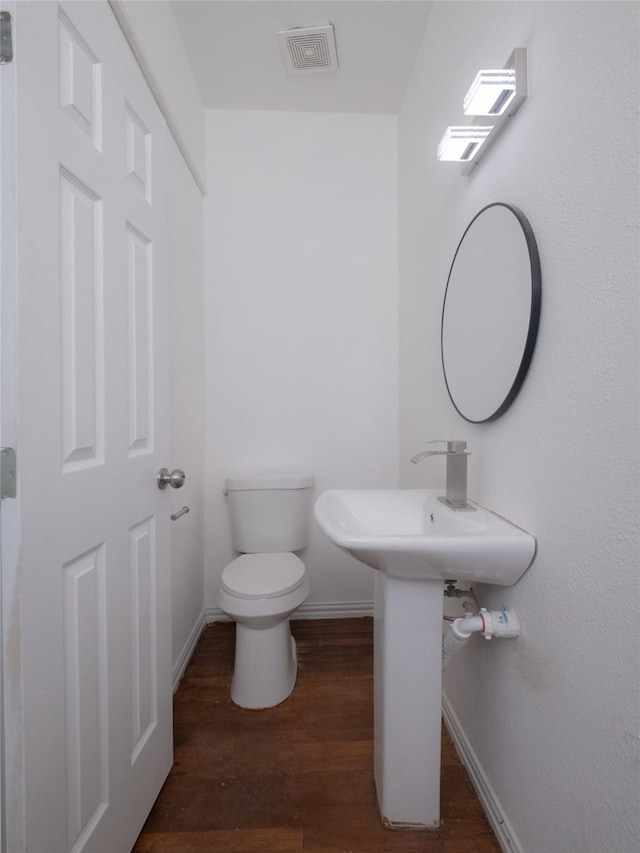 2703 Areba St, Houston, TX 77091 - half bath featuring toilet, baseboards, and wood finished floors