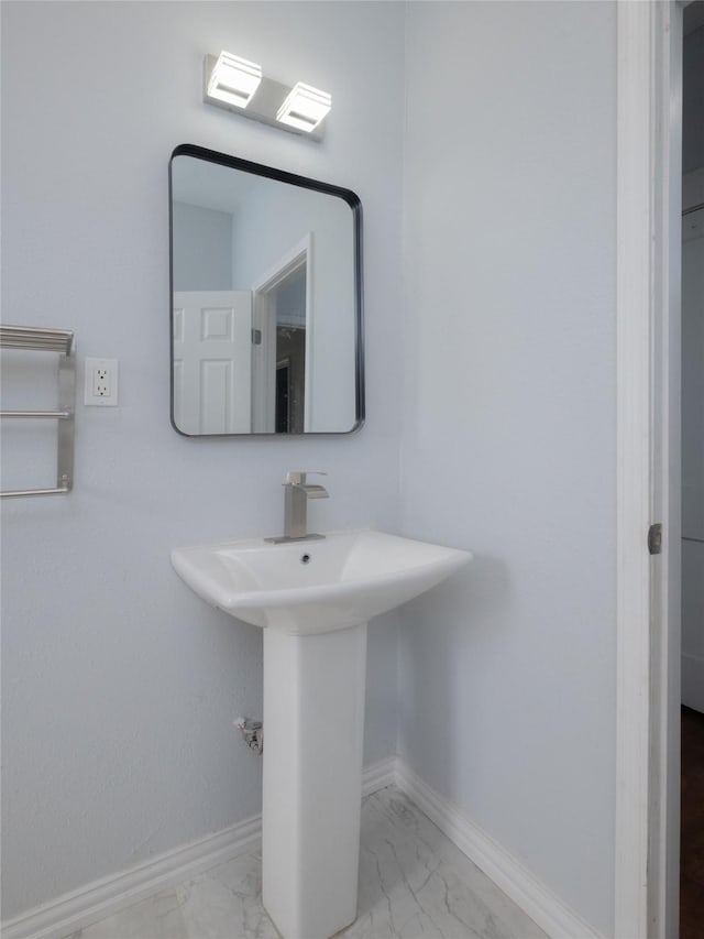 2703 Areba St, Houston, TX 77091 - bathroom featuring marble look tile flooring, baseboards, and a sink