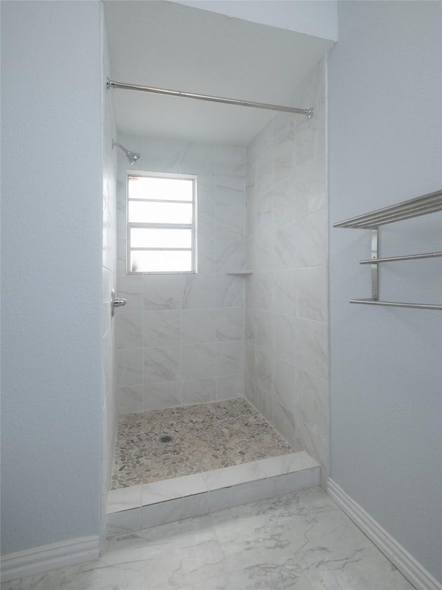 2703 Areba St, Houston, TX 77091 - full bath with tiled shower, marble finish flooring, and baseboards