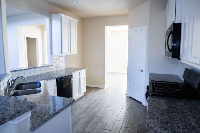 40575 Goldeneye Pl, Magnolia, TX 77354 - kitchen with black dishwasher, a sink, white cabinets, and dark wood-style floors