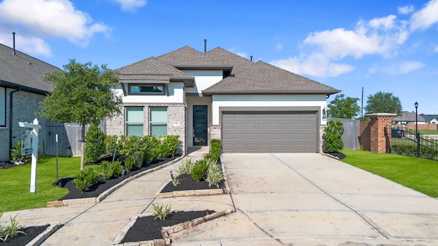 1963 Waters Branch Dr, Missouri City, TX 77459 - view of front facade featuring stucco siding, a garage, driveway, roof with shingles, and brick siding