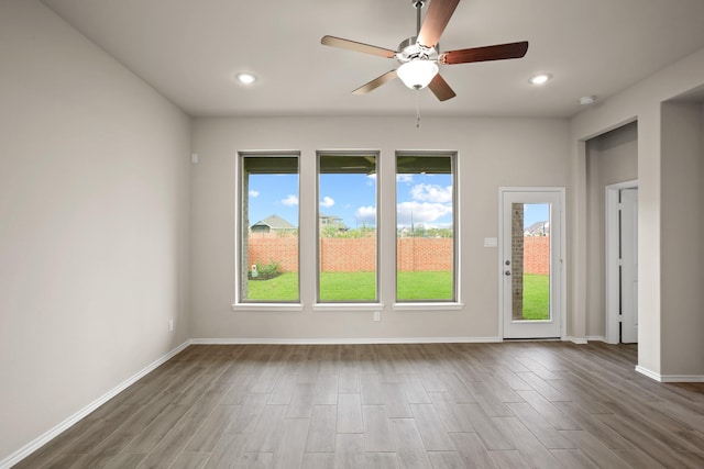 1963 Waters Branch Dr, Missouri City, TX 77459 - empty room featuring ceiling fan, plenty of natural light, wood finished floors, and recessed lighting