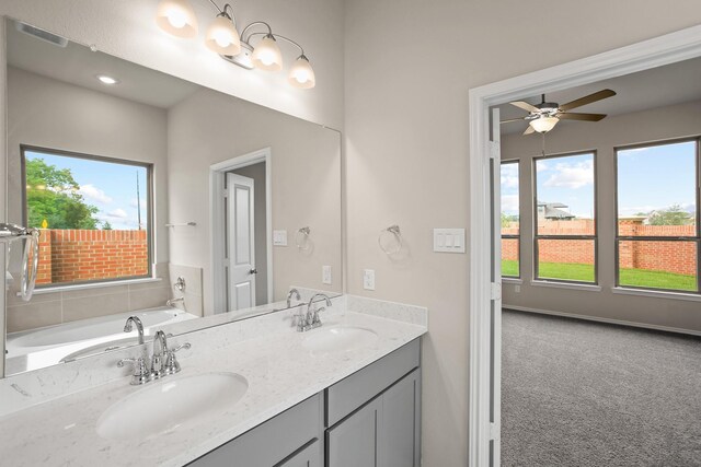 1963 Waters Branch Dr, Missouri City, TX 77459 - bathroom with healthy amount of natural light, double vanity, a garden tub, and ceiling fan