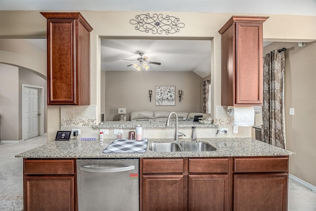 8406 Quiet Bay Dr, Baytown, TX 77523 - kitchen with stainless steel dishwasher, a sink, ceiling fan, arched walkways, and backsplash