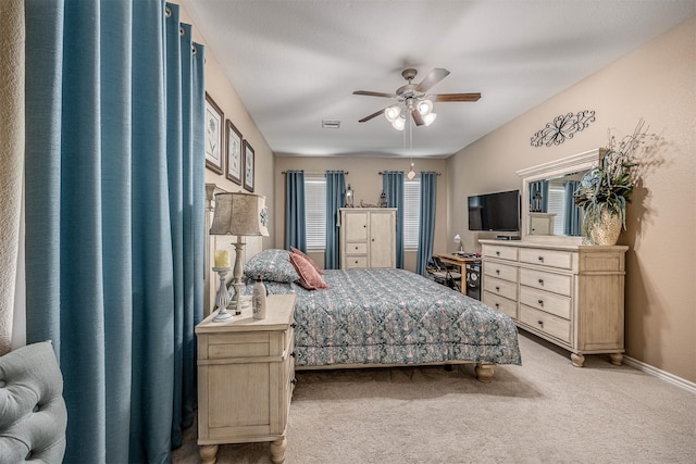 8406 Quiet Bay Dr, Baytown, TX 77523 - bedroom with light colored carpet, baseboards, and a ceiling fan