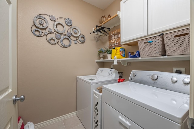 8406 Quiet Bay Dr, Baytown, TX 77523 - laundry area with washing machine and clothes dryer, light tile patterned floors, baseboards, and cabinet space