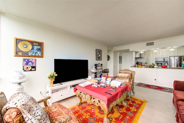 5001 Woodway Dr Unit 1405, Houston, TX 77056 - living room with a textured ceiling, ornamental molding, and light wood finished floors