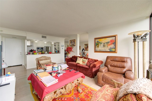 5001 Woodway Dr Unit 1405, Houston, TX 77056 - living area with crown molding, a textured ceiling, and wood finished floors