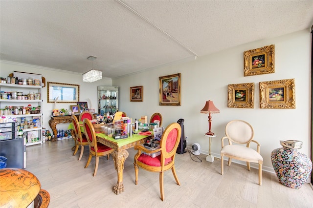 5001 Woodway Dr Unit 1405, Houston, TX 77056 - dining space featuring a textured ceiling and light wood-style flooring
