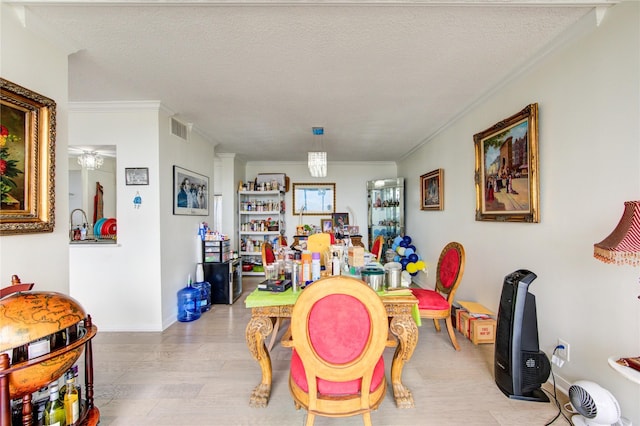 5001 Woodway Dr Unit 1405, Houston, TX 77056 - game room featuring wood finished floors, crown molding, baseboards, and a textured ceiling