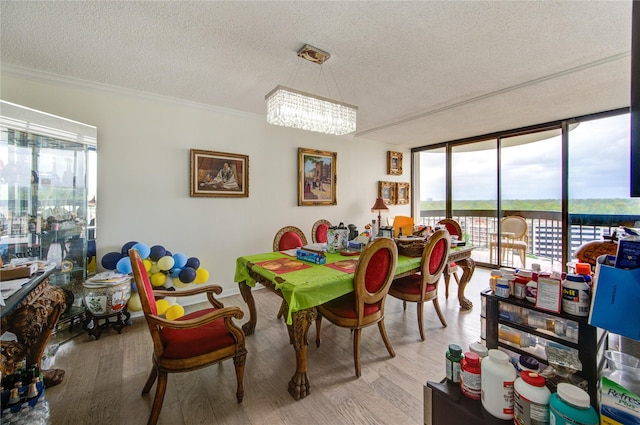 5001 Woodway Dr Unit 1405, Houston, TX 77056 - dining space with a textured ceiling, a chandelier, wood finished floors, floor to ceiling windows, and crown molding