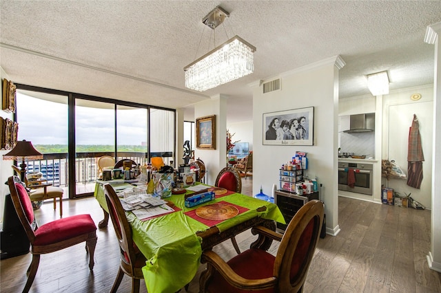 5001 Woodway Dr Unit 1405, Houston, TX 77056 - dining room with expansive windows, a textured ceiling, a chandelier, dark wood-type flooring, and crown molding