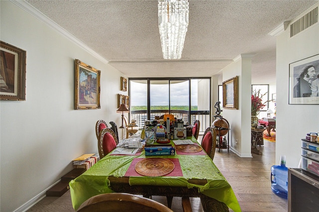 5001 Woodway Dr Unit 1405, Houston, TX 77056 - dining space with a textured ceiling, a chandelier, wood finished floors, crown molding, and baseboards