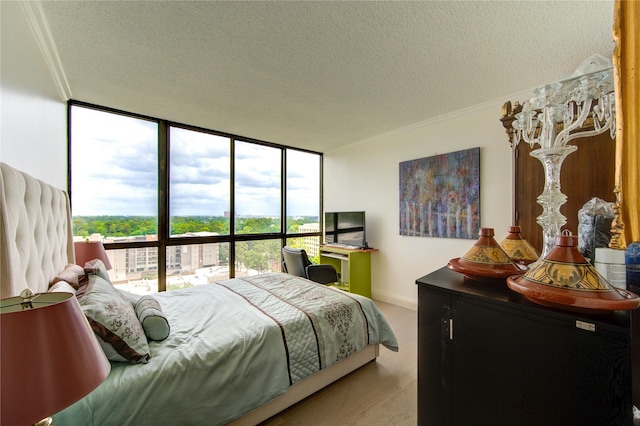 5001 Woodway Dr Unit 1405, Houston, TX 77056 - bedroom with a textured ceiling, expansive windows, multiple windows, ornamental molding, and baseboards
