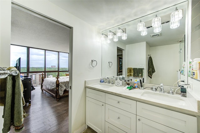 5001 Woodway Dr Unit 1405, Houston, TX 77056 - full bathroom featuring double vanity, ensuite bath, and wood finished floors