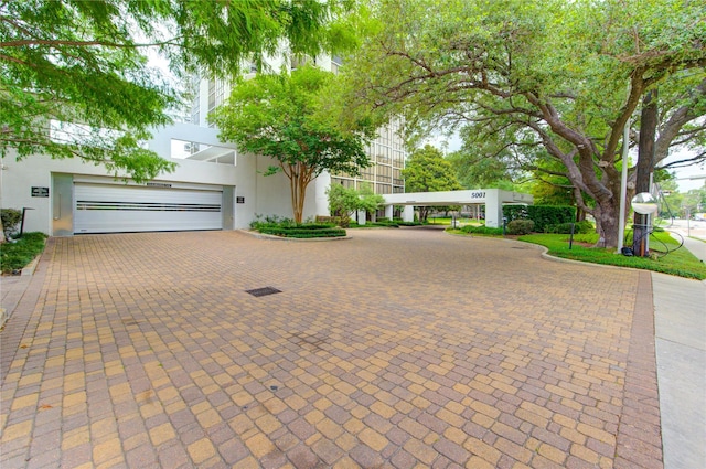 5001 Woodway Dr Unit 1405, Houston, TX 77056 - art deco inspired home featuring decorative driveway, stucco siding, and a garage