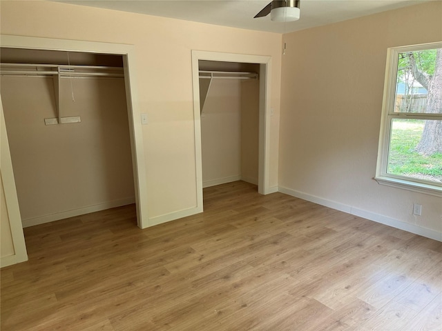 8117 Snowden St, Houston, TX 77028 - unfurnished bedroom featuring multiple closets, light wood-style flooring, baseboards, and ceiling fan