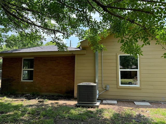 8117 Snowden St, Houston, TX 77028 - view of side of home with cooling unit and brick siding
