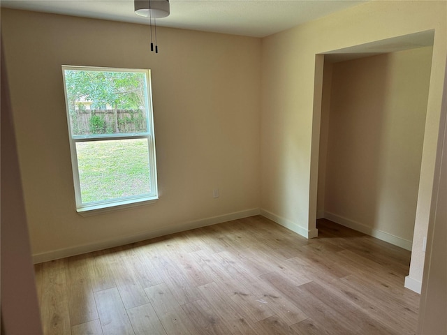 8117 Snowden St, Houston, TX 77028 - empty room with light wood-type flooring, healthy amount of natural light, and baseboards