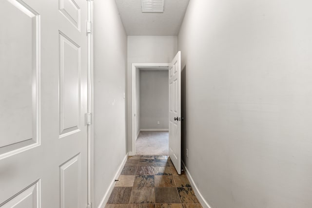 1333 W 21st St Unit B, Houston, TX 77008 - hallway with baseboards, stone finish floors, and a textured ceiling