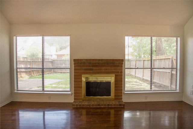 7331 Burkridge Dr, Houston, TX 77041 - unfurnished living room featuring wood finished floors, baseboards, plenty of natural light, a brick fireplace, and lofted ceiling